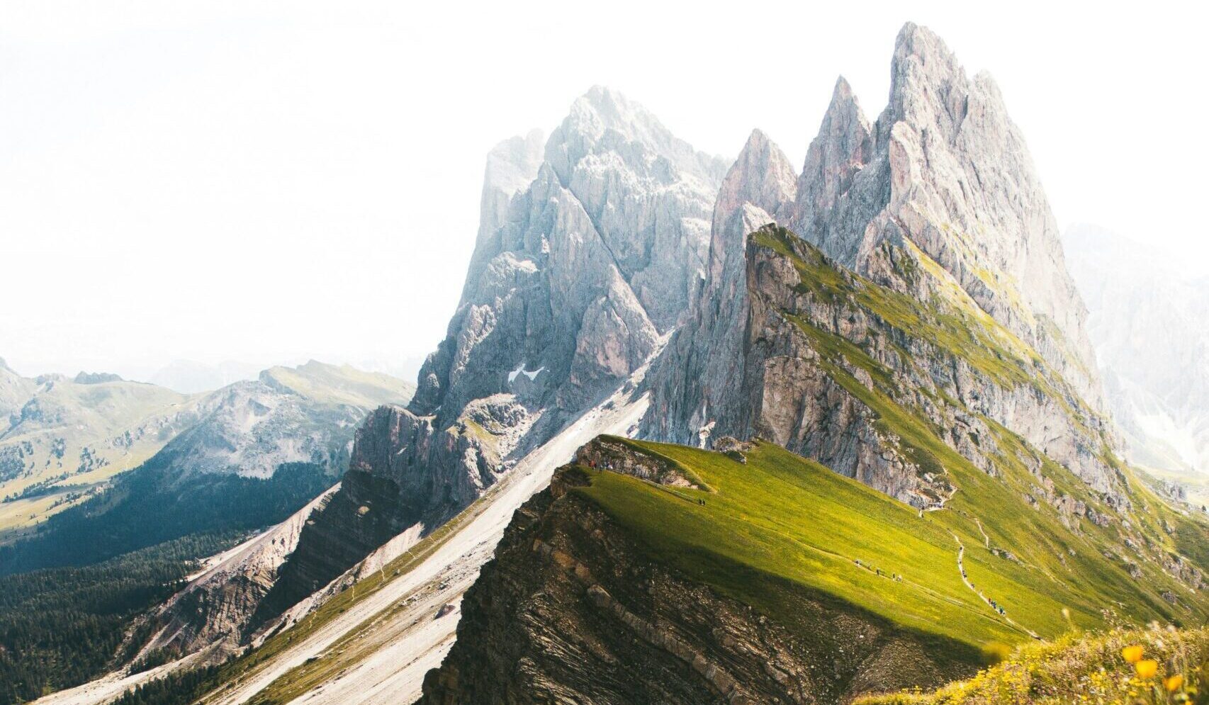 A serene mountain landscape through lush green hills, symbolizing the journey of perseverance and personal growth.
